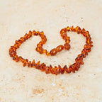 Collier de dentition ambre  cognac